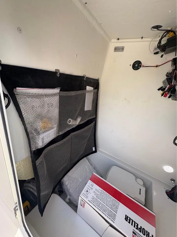 Slide: The Image of Interior of 2026 Parker 210 COASTAL boat with storage net and equipment. - 13