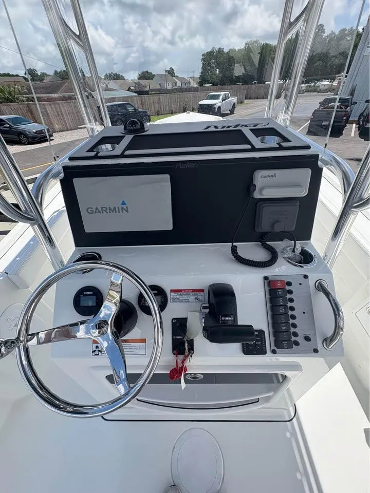 Slide: The Image of 2026 Parker 210 COASTAL boat dashboard with Garmin navigation system and steering wheel. - 6