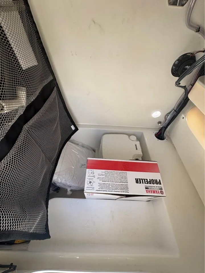 Slide: The Image of Storage compartment in a 2026 Parker 210 COASTAL boat with Yamaha propeller box. - 9