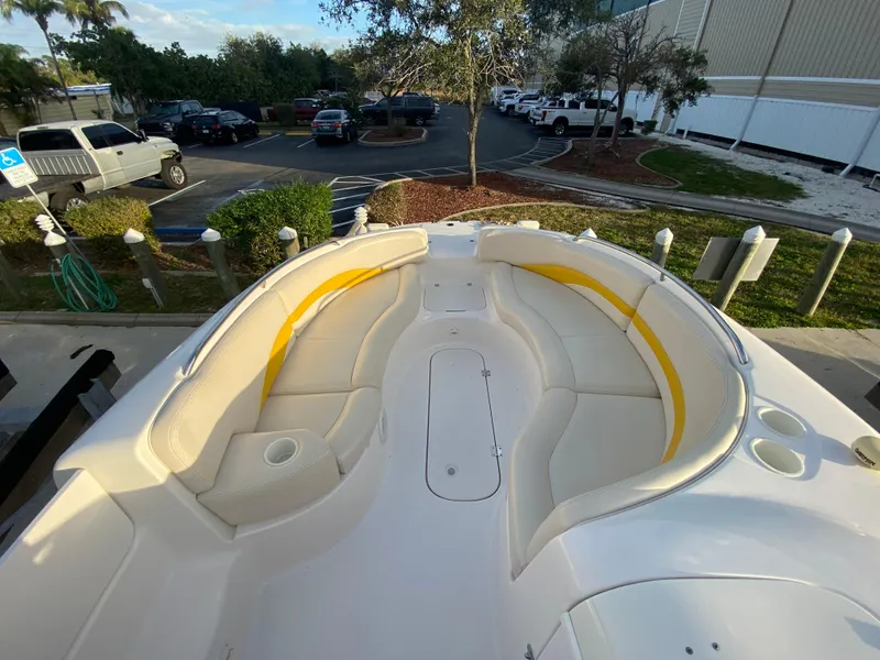 Slide: The Image of 2001 Chaparral Sunesta 232 boat with spacious seating, parked near a lot. - 13