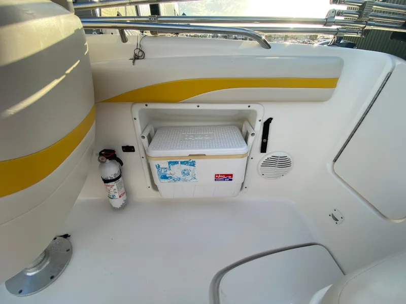 Slide: The Image of 2001 Chaparral Sunesta 232 boat interior with cooler, fire extinguisher, and speaker. - 23