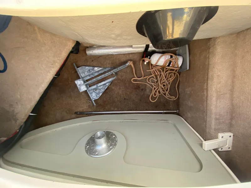 Slide: The Image of Storage compartment of 2001 Chaparral Sunesta 232 with anchor, rope, and fire extinguisher. - 25