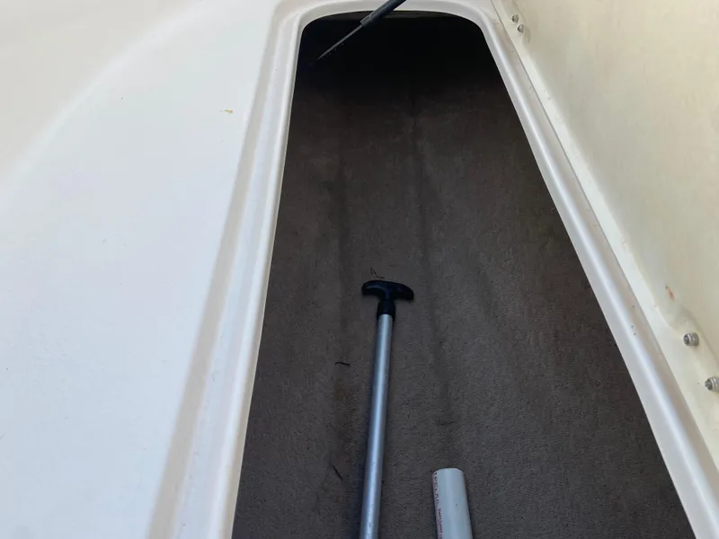 Slide: The Image of Storage compartment of 2001 Chaparral Sunesta 232 boat with tools inside. - 27