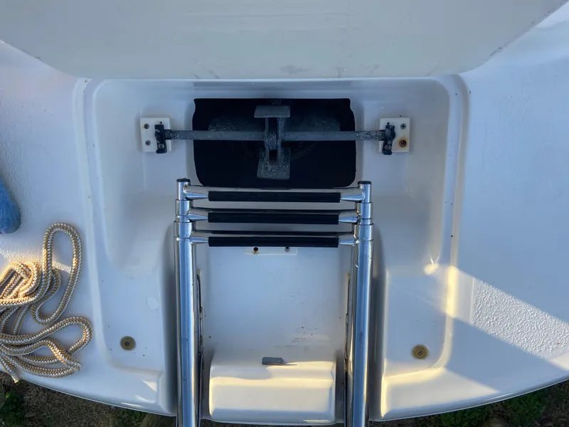 Slide: The Image of 2001 Chaparral Sunesta 232 boat ladder and anchor compartment with rope. - 29