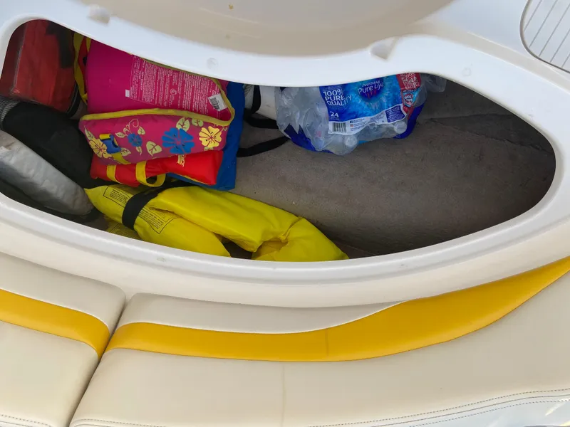 Slide: The Image of Storage compartment in a 2001 Chaparral Sunesta 232 boat with life jackets and water bottles. - 30