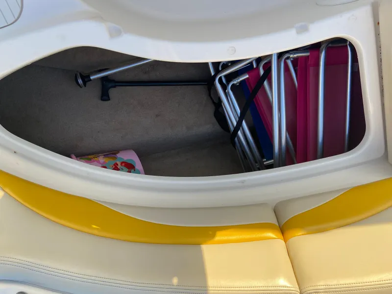 Slide: The Image of Storage compartment in a 2001 Chaparral Sunesta 232 boat with chairs and accessories. - 31