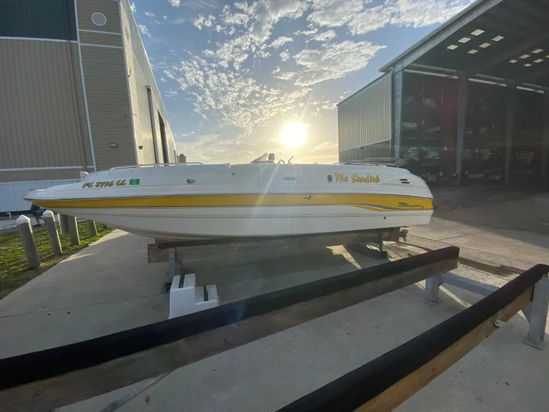 Slide: The Image of 2001 Chaparral Sunesta 232 boat on trailer, sunset background, near storage facility. - 8