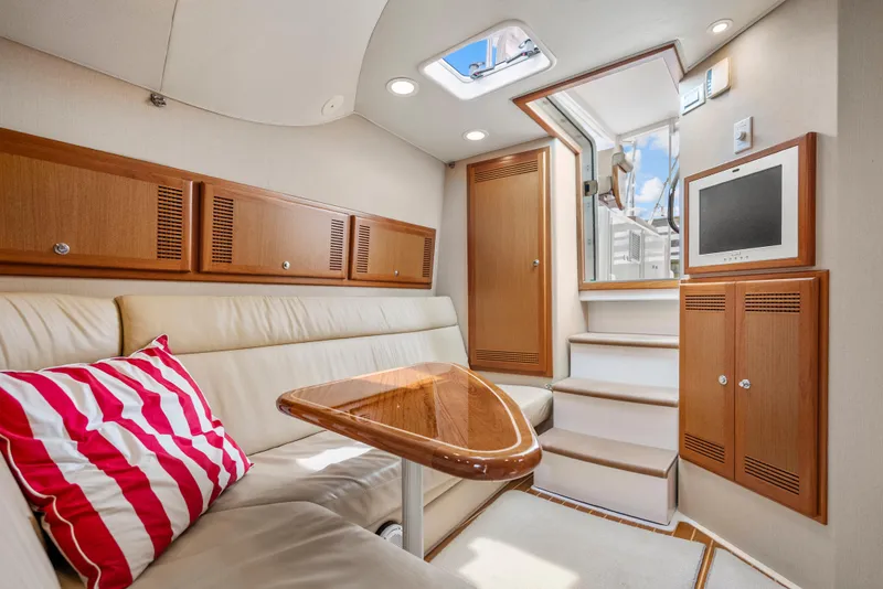 Slide: The Image of Luxurious interior of 2004 Cabo 40 Express yacht with leather seating and wooden accents. - 17