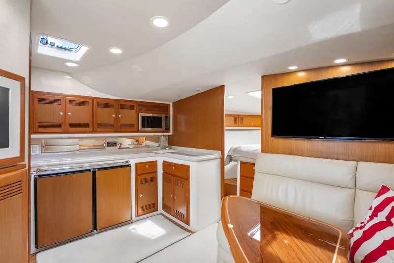 Slide: The Image of Luxurious 2004 Cabo 40 Express yacht interior with modern kitchen and cozy seating area. - 18