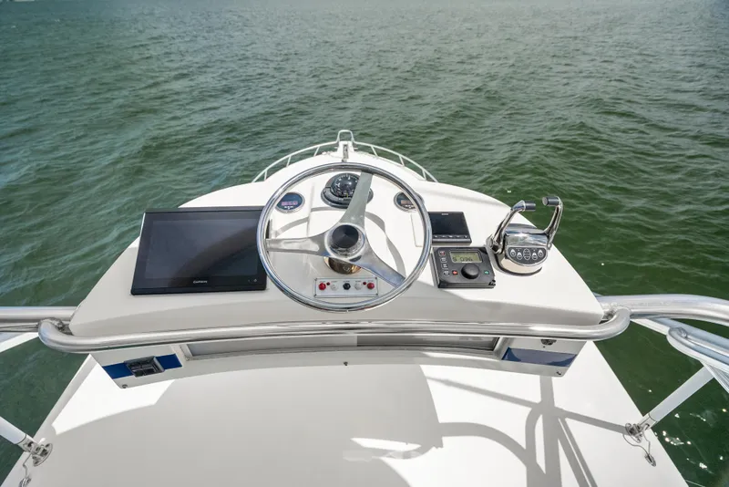 Slide: The Image of Helm of 2004 Cabo 40 Express boat with steering wheel and navigation equipment. - 19