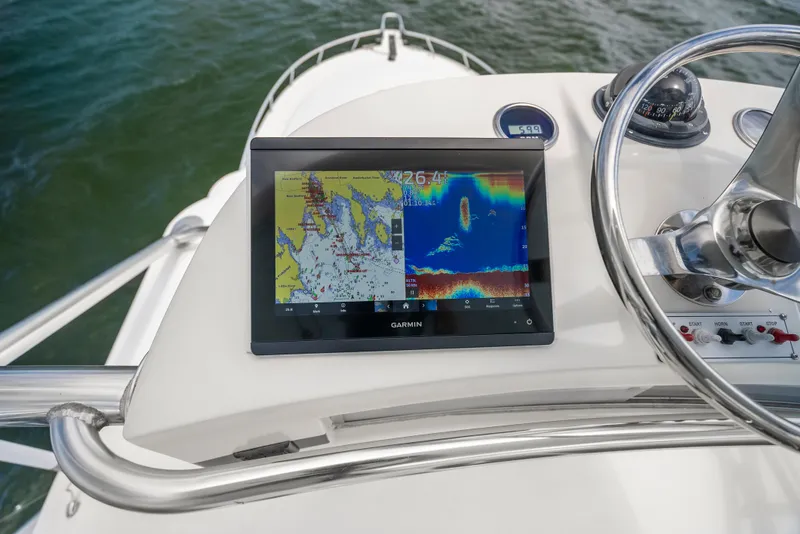 Slide: The Image of Helm of 2004 Cabo 40 Express with Garmin navigation display and steering wheel. - 20