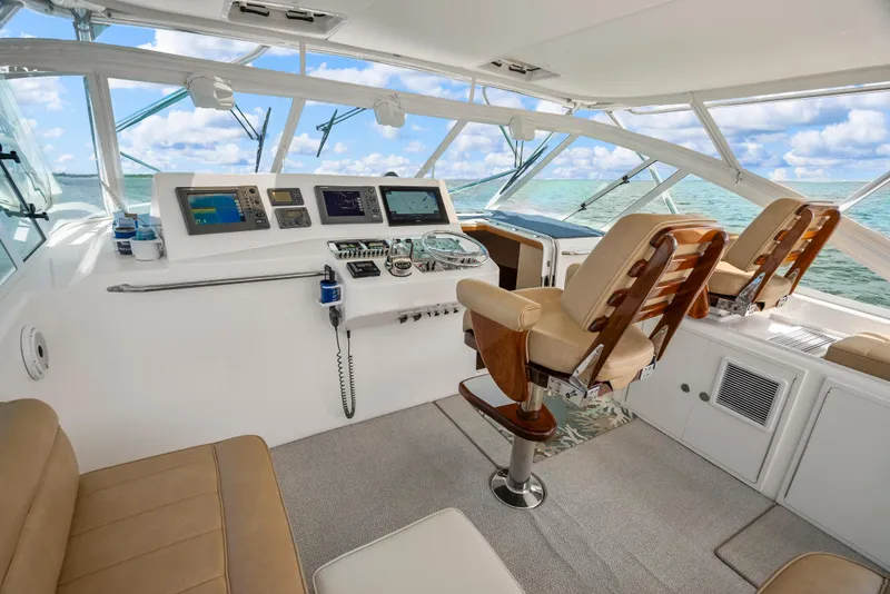 Slide: The Image of Luxurious 2004 Cabo 40 Express yacht cockpit with leather seating and advanced navigation systems. - 24