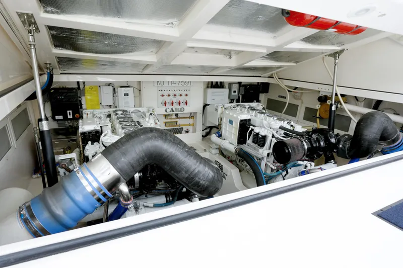 Slide: The Image of Engine room of 2004 Cabo 40 Express yacht, showcasing dual engines and mechanical components. - 25