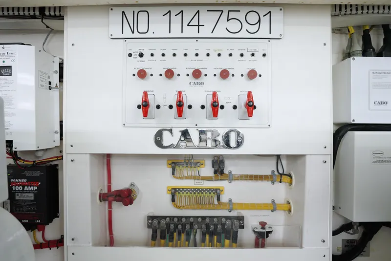 Slide: The Image of Electrical panel of 2004 Cabo 40 Express boat with switches and wiring. - 26