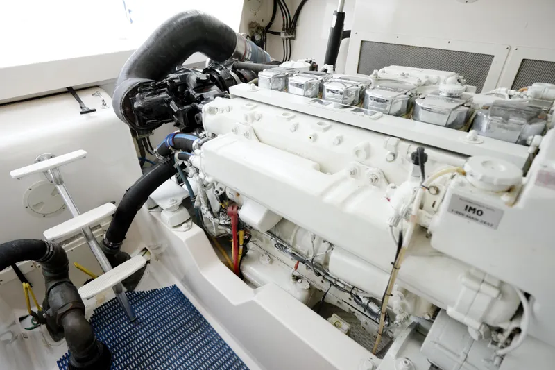 Slide: The Image of Engine room of 2004 Cabo 40 Express yacht, showcasing detailed machinery and components. - 27