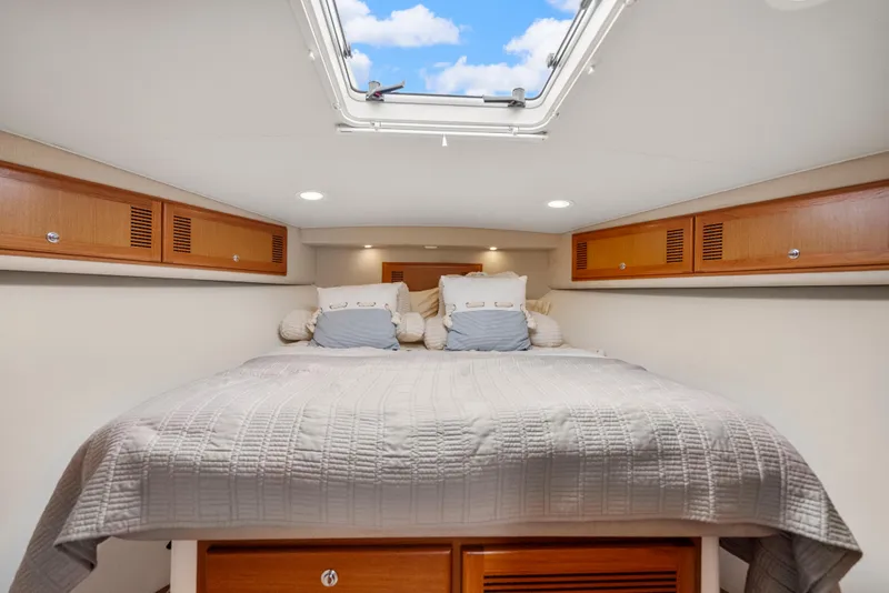 Slide: The Image of Luxurious cabin interior of 2004 Cabo 40 Express yacht with skylight and cozy bedding. - 3