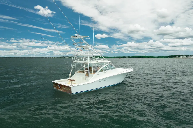 Slide: The Image of 2004 Cabo 40 Express boat on open water under a partly cloudy sky. - 7