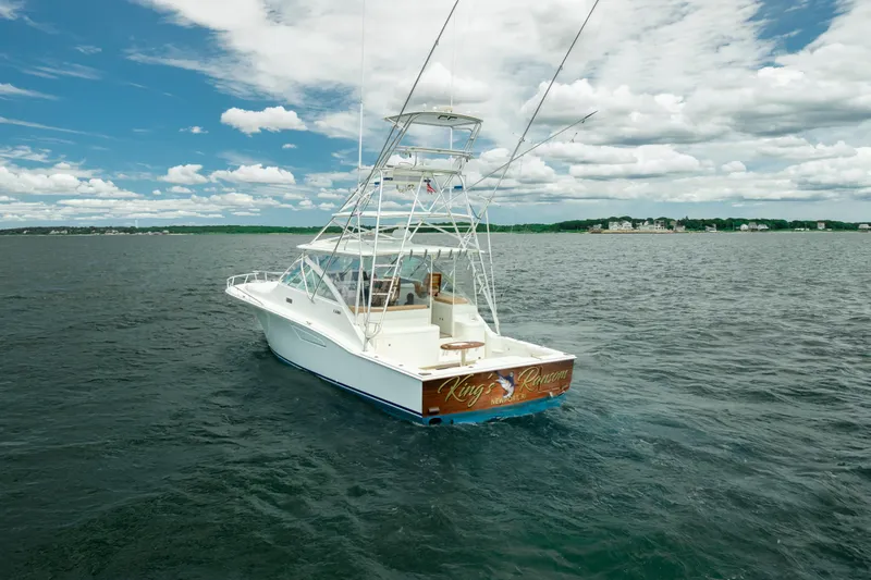 Slide: The Image of 2004 Cabo 40 Express boat on open water under a partly cloudy sky. - 9