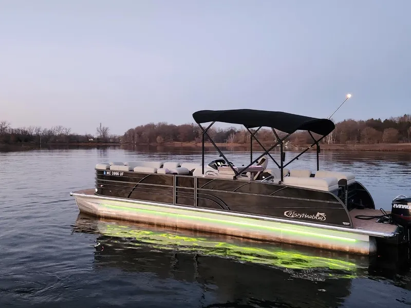 Slide: The Image of 2019 Misty Harbor 2685 Skye SE pontoon boat on calm lake at dusk. - 12