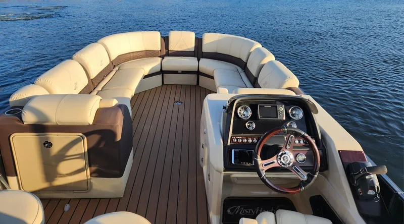 Slide: The Image of 2019 Misty Harbor 2685 Skye SE pontoon boat with luxurious seating and modern dashboard on water. - 15