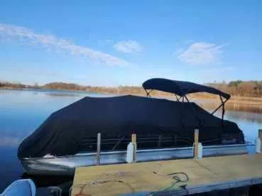 Slide: The Image of 2019 Misty Harbor 2685 Skye SE pontoon boat covered at dock, serene lake backdrop. - 9