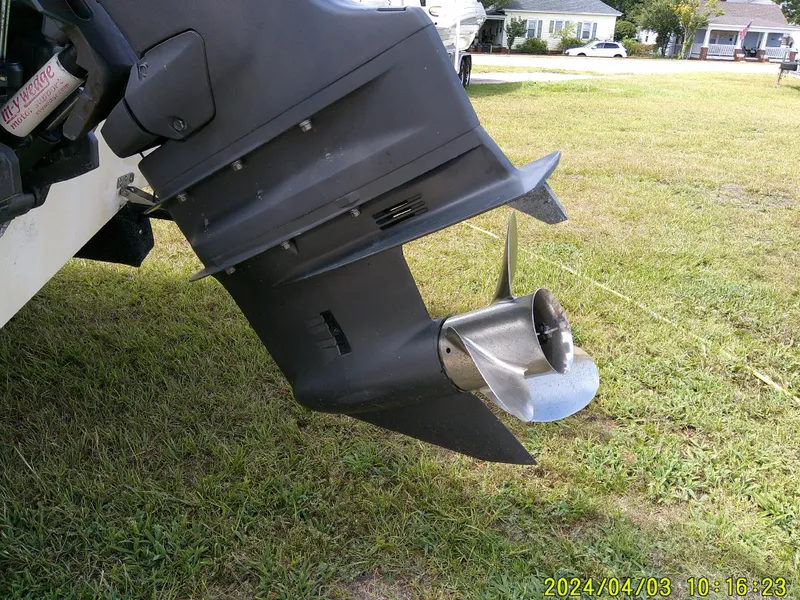 Slide: The Image of Outboard motor of a 2008 Parker 2120 Sport Cabin on grass. - 13