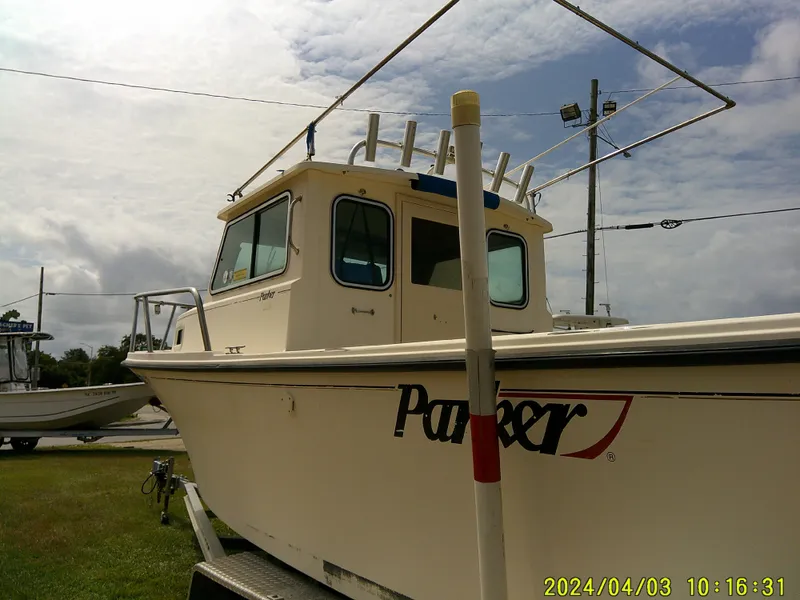 Slide: The Image of 2008 Parker 2120 Sport Cabin boat on trailer, cloudy sky background. - 14