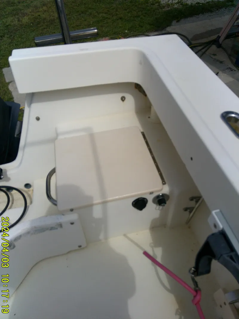 Slide: The Image of 2008 Parker 2120 Sport Cabin boat interior with seating and control panel. - 17