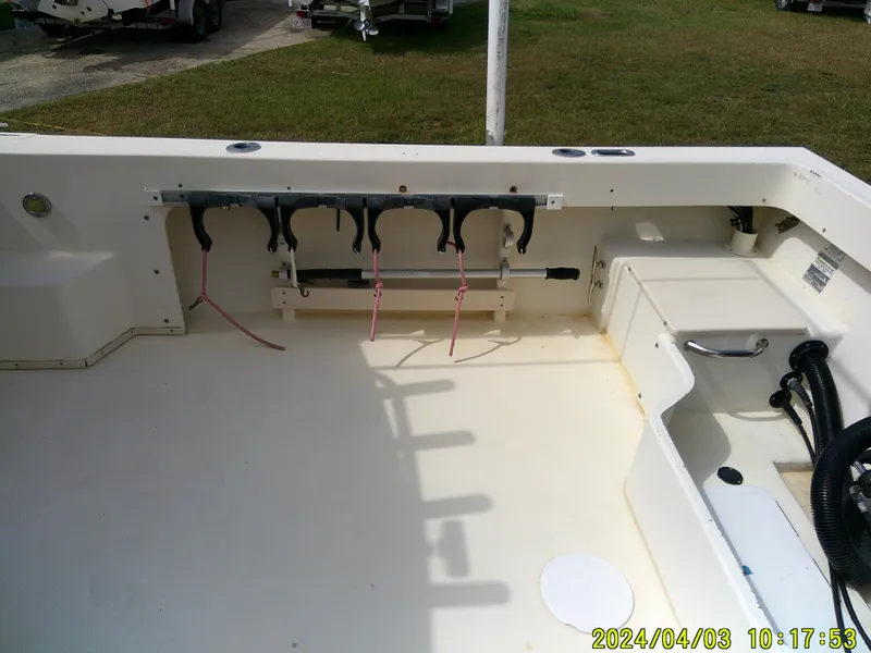 Slide: The Image of 2008 Parker 2120 Sport Cabin boat interior with rod holders and storage compartments. - 20