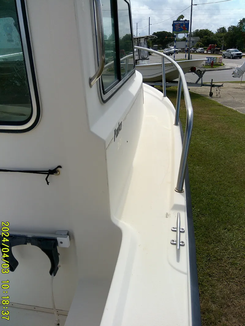 Slide: The Image of 2008 Parker 2120 Sport Cabin boat side view with railing and window. - 27