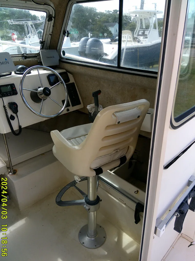 Slide: The Image of 2008 Parker 2120 Sport Cabin interior with steering wheel and captain's chair. - 30