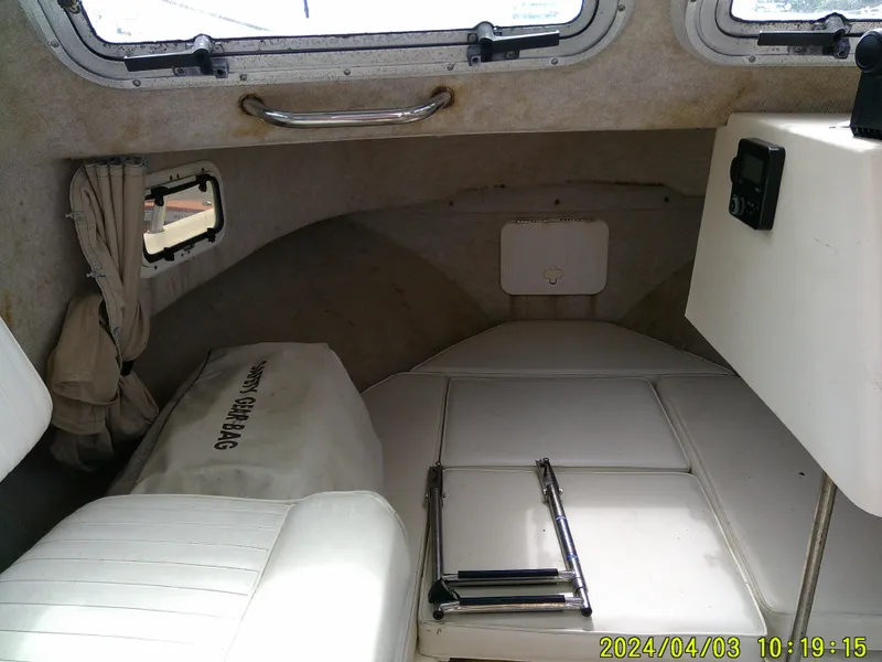 Slide: The Image of Interior of a 2008 Parker 2120 Sport Cabin boat with seating and storage. - 32