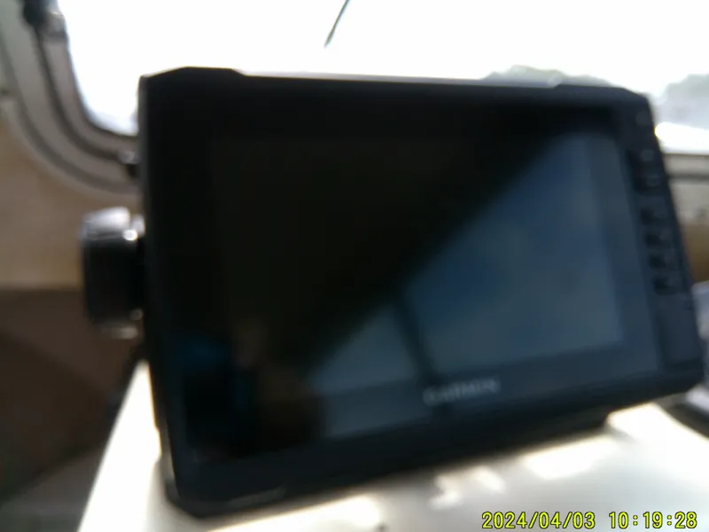 Slide: The Image of Blurred Garmin device inside a 2008 Parker 2120 Sport Cabin boat. - 35