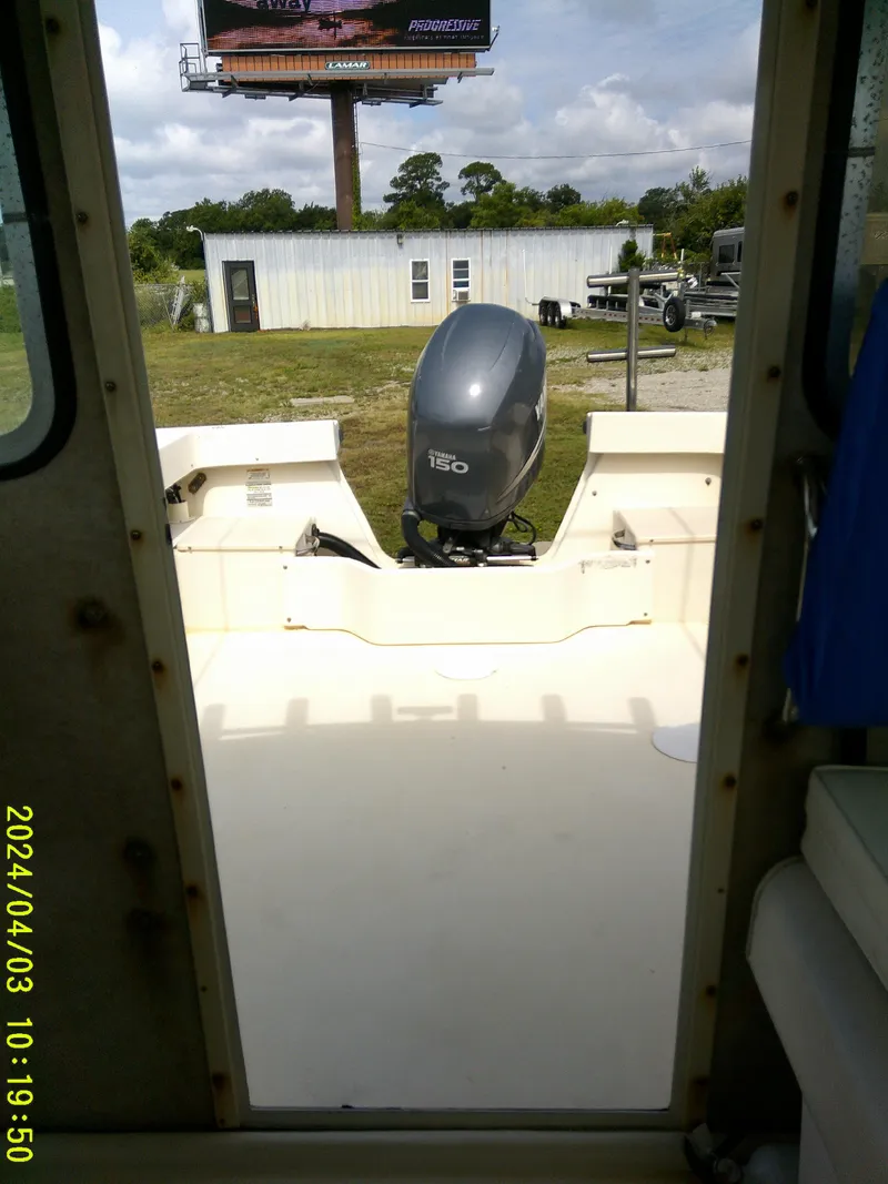Slide: The Image of 2008 Parker 2120 Sport Cabin boat with outboard motor, viewed from cabin interior. - 38