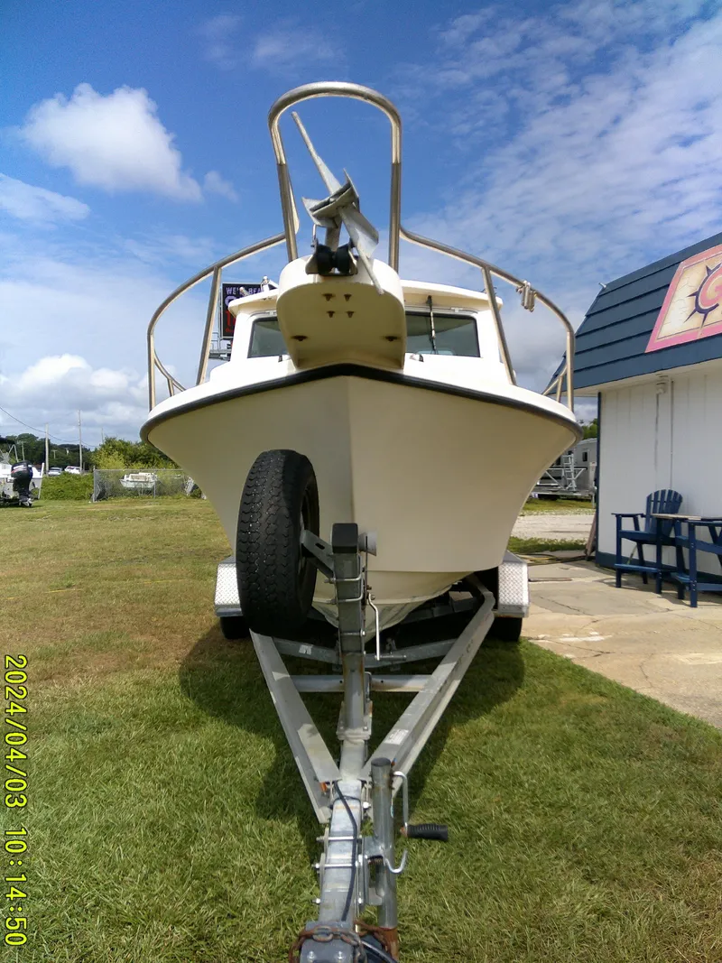 Slide: The Image of 2008 Parker 2120 Sport Cabin boat on trailer, grassy area, clear sky. - 4