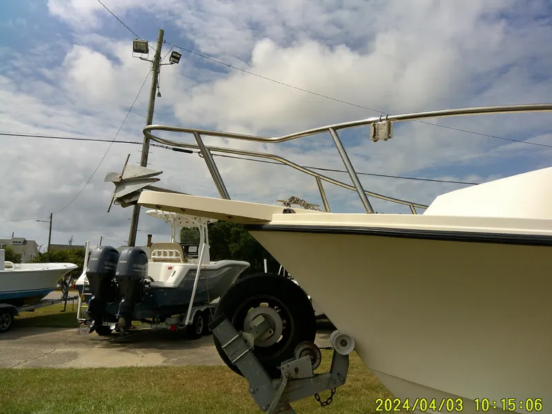 Slide: The Image of 2008 Parker 2120 Sport Cabin boat on trailer, with Yamaha engines in background. - 5