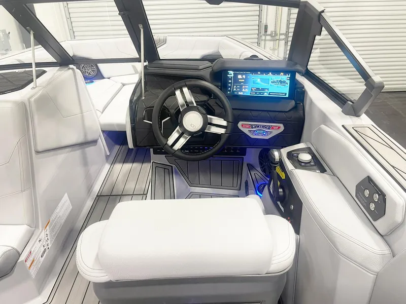 Slide: The Image of Interior of 2025 Nautique Super Air Nautique GS24 boat with modern dashboard and steering wheel. - 11