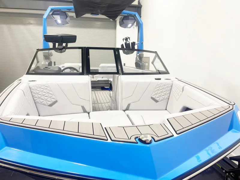 Slide: The Image of 2025 Nautique Super Air Nautique GS24 boat interior with blue and white design. - 4