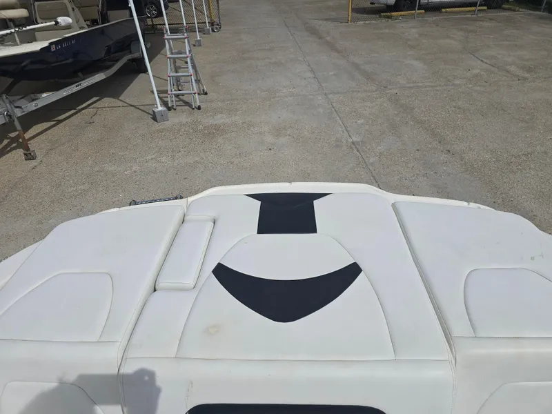 Slide: The Image of 2016 Chaparral 18 H2O Sport boat interior with white and black seating. - 11