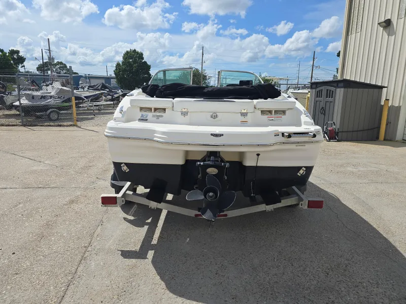Slide: The Image of 2016 Chaparral 18 H2O Sport boat on trailer, parked outdoors under a cloudy sky. - 4