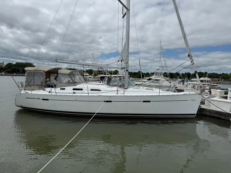 The Image of 2003 Beneteau 393 sailboat docked at marina under cloudy sky. - 0