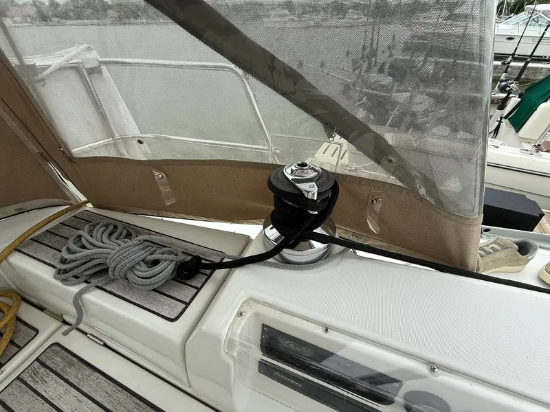 Slide: The Image of Beneteau 393 sailboat deck with winch and coiled rope, 2003 model. - 14