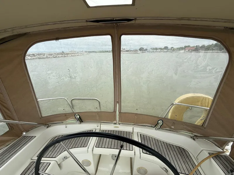 Slide: The Image of Interior view from a 2003 Beneteau 393 sailboat cockpit, overlooking calm waters. - 15