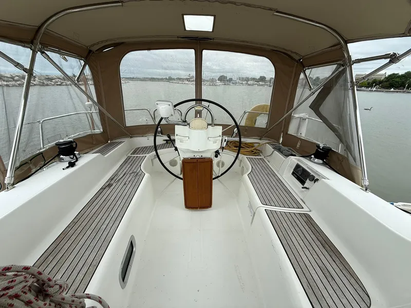 Slide: The Image of Cockpit of 2003 Beneteau 393 sailboat with steering wheel and wooden deck. - 17