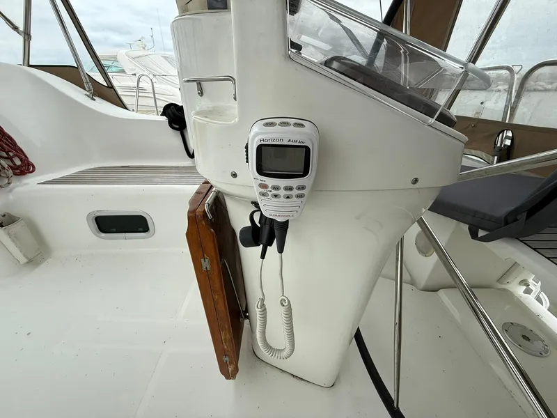 Slide: The Image of Cockpit of 2003 Beneteau 393 sailboat with radio equipment and steering console. - 25