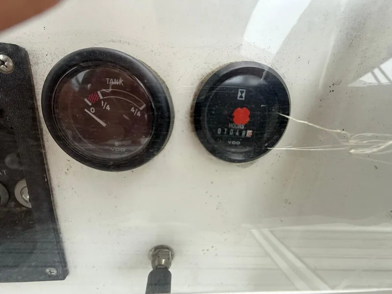 Slide: The Image of Close-up of Beneteau 393 2003 boat gauges, showing tank and hour meters. - 26