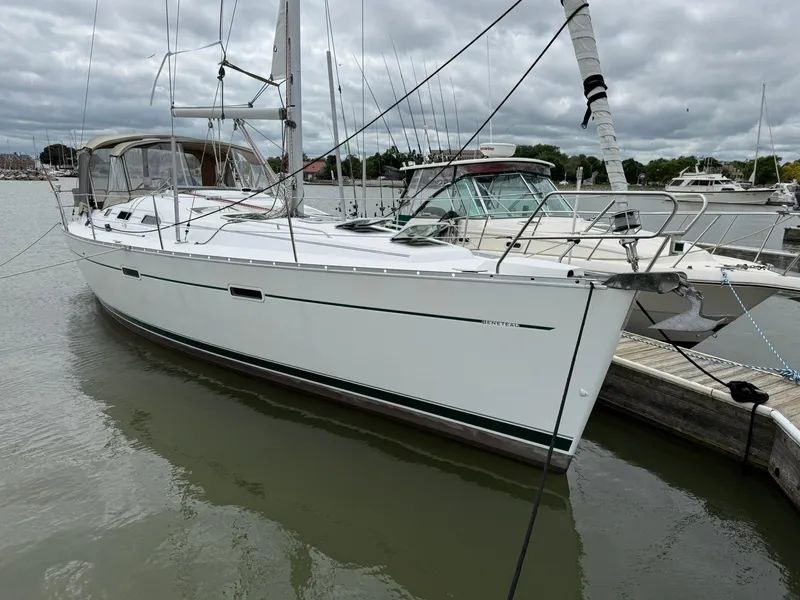 Slide: The Image of 2003 Beneteau 393 sailboat docked in a marina under cloudy skies. - 3