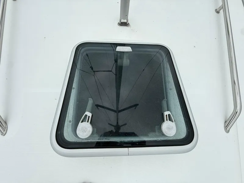 Slide: The Image of Deck hatch of a 2003 Beneteau 393 sailboat, featuring stainless steel handles. - 32