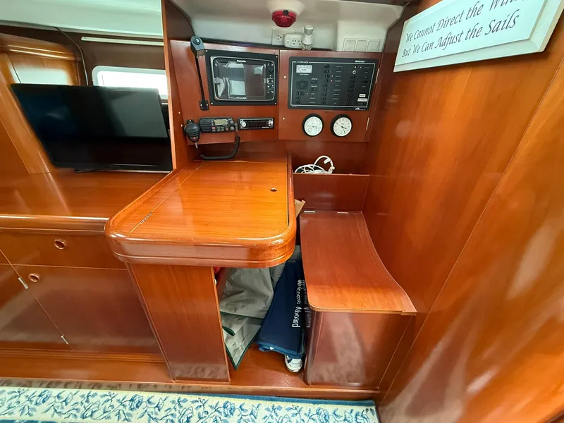 Slide: The Image of Interior of 2003 Beneteau 393 yacht with navigation station and wooden finish. - 35