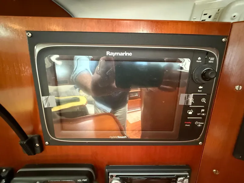 Slide: The Image of Raymarine navigation system on 2003 Beneteau 393 yacht, featuring hybrid touch controls. - 39